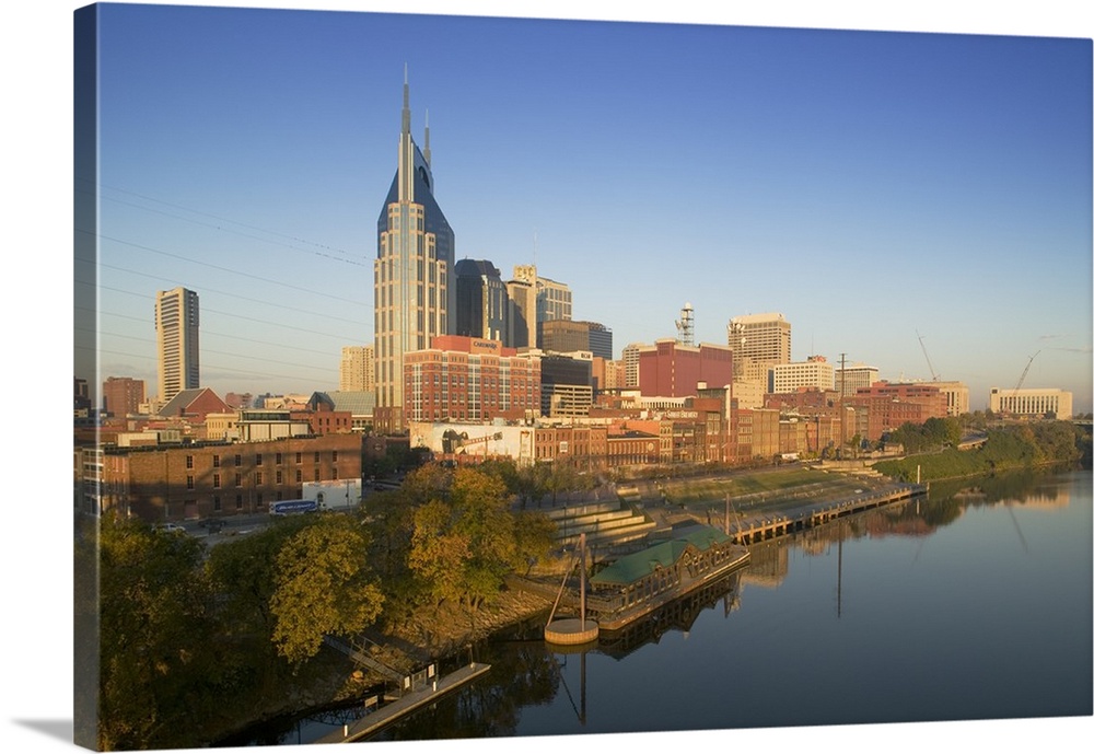 This oversize piece is a photograph taken of the skyline in Nashville that sits along a body of water.