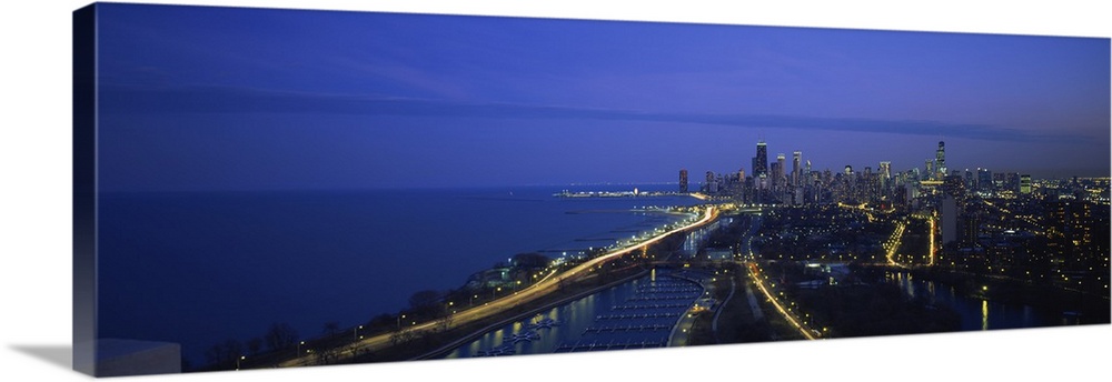 High angle view of buildings lit up at dusk, Lake Michigan, Chicago, Illinois