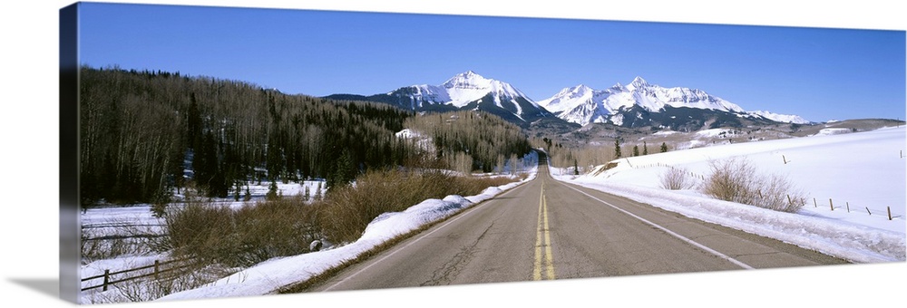 Highway in front of snowcapped mountains, Telluride, Colorado
