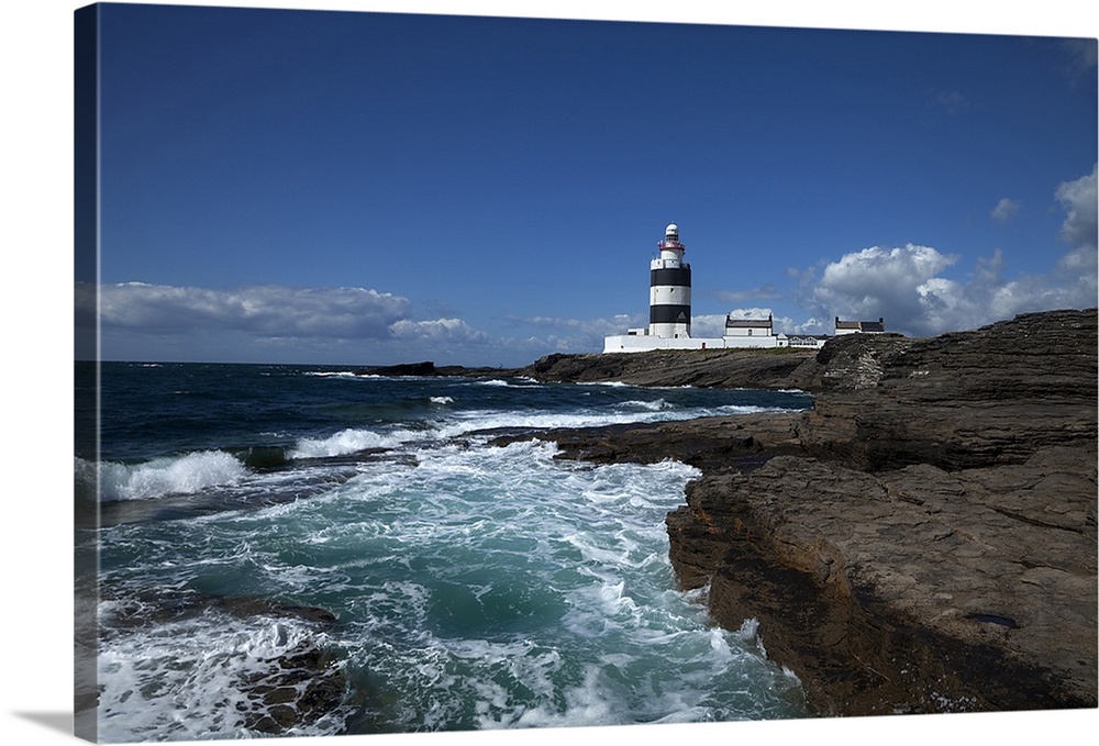 Landscape photograph on a giant canvas of waves crashing into the rocky shoreline in County Wexford, Ireland.  Hook Head L...