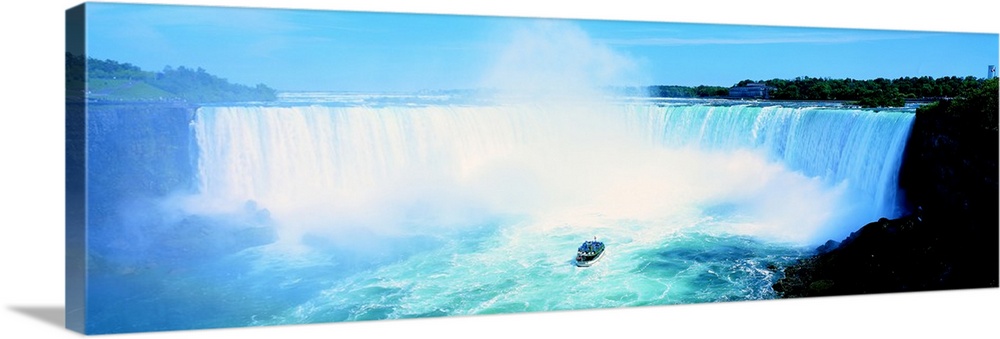 Long wall art of Niagara Falls rushing downward and a boat of tourists approaching it from the bottom.
