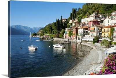 Houses at waterfront with boats on Lake Como, Varenna, Lombardy, Italy