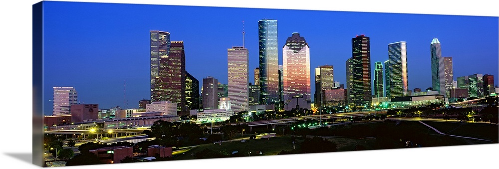 Decorative artwork for the home or office this photograph captures the city skyline and surrounded road ways on a panorami...
