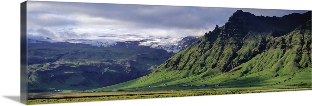 Iceland, South Coast, Sheer Basalt Cliffs, View of farm and cliff in the south coast