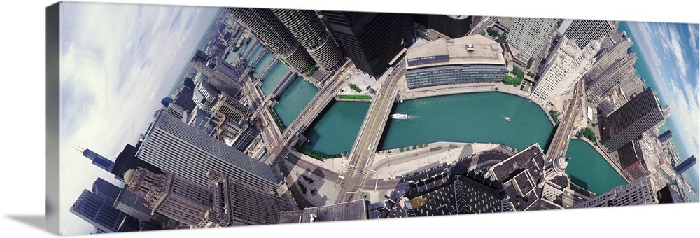A wide angle photograph taken from an aerial view of the Chicago skyline with the river running through it.