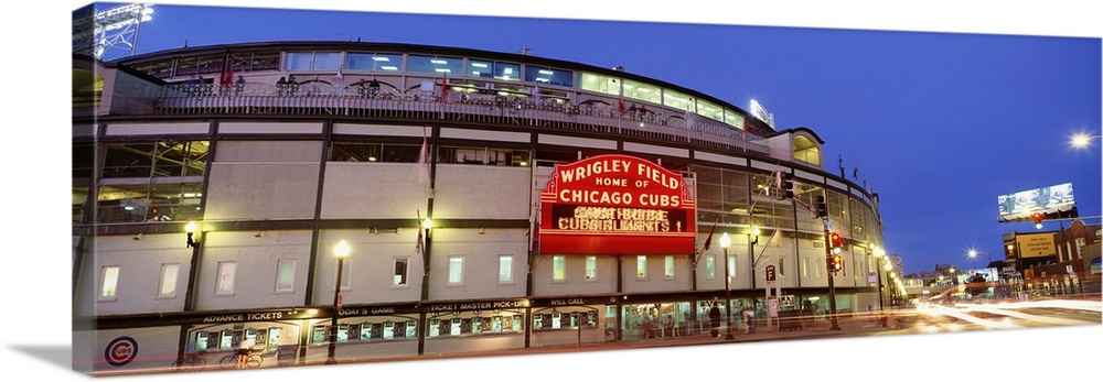 Panoramic photograph displays a nighttime view of the famous marquee sitting outside Wrigley Field, the home of a Major Le...