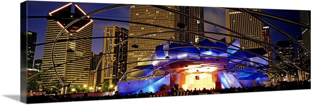 Wide angle photograph taken of an elaborate stage with a performance at night in the city of Chicago.