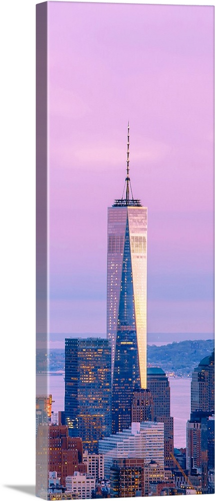 Illuminated One World Trade Center amidst buildings against sky in city at dusk, Manhattan, New York City, New York State,...