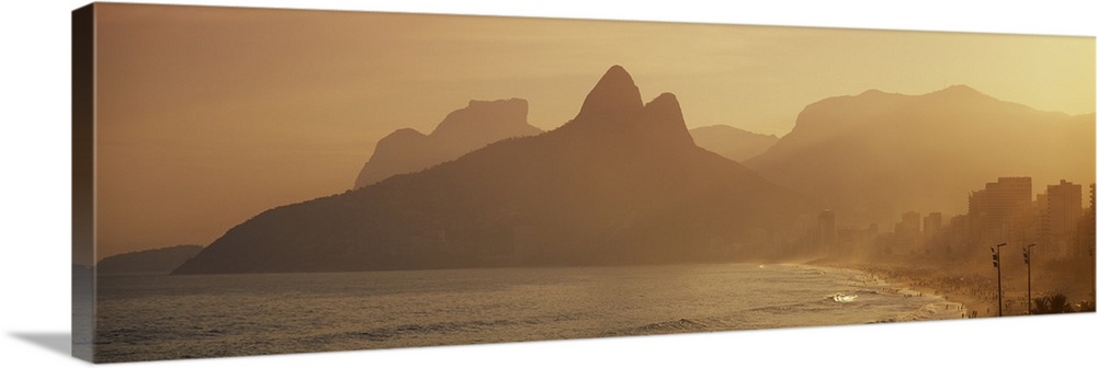 Giant landscape photograph of silhouetted mountains near the coast of Ipanema Beach in Rio de Janeiro, Brazil.