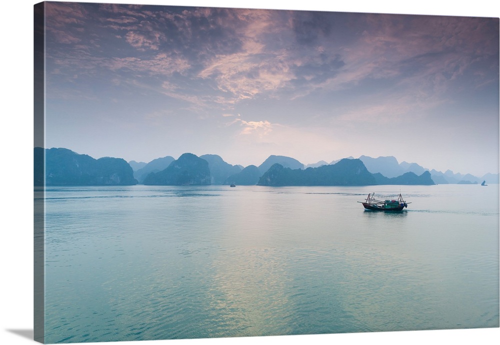 Islands and boat in the pacific ocean, ha long bay, quang ninh province, vietnam.