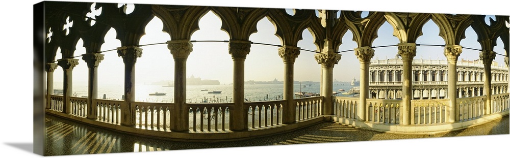 Panoramic photo of decorative colomns in Italy over looking the ocean.