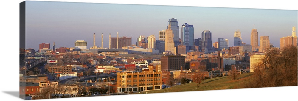 Big, landscape photograph taken from a hillside, of the Kansas City skyline, including the Power and Light building.