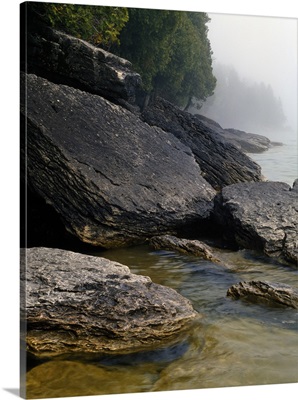 Large boulders on misty Lake Michigan shoreline, Newport Bay, Newport State Park, Wisconsin