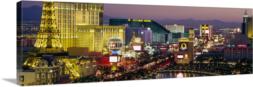 Panoramic photograph taken of the Las Vegas skyline at night with the bright lights of the buildings shown.