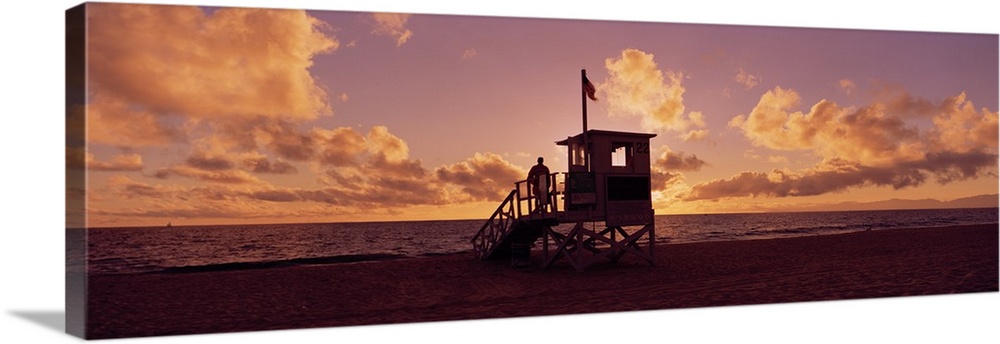 Landscape photograph on a big canvas of the 22nd Street lifeguard station on Redondo Beach, silhouetted by the setting sun...