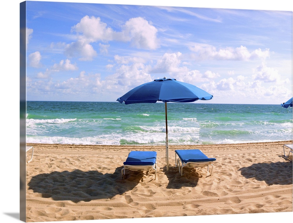 Lounge chairs and beach umbrella on the beach, Fort Lauderdale Beach, Florida