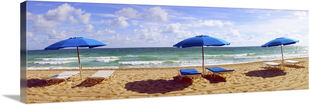 Lounge chairs and beach umbrellas on the beach, Fort Lauderdale Beach, Florida