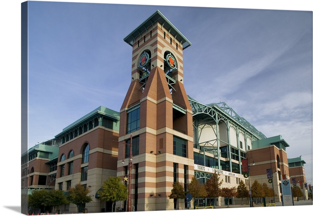 The front of the Houston Astros stadium is photographed from below and looking up toward the top of one of the corners.