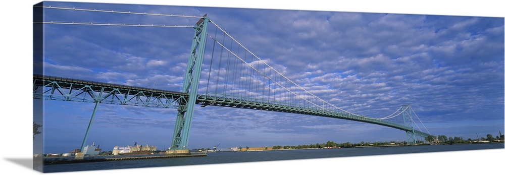 Long and horizontal image print of a long bridge spanning across the river in Detroit.