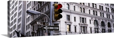 Low angle view of a traffic light in front of a building, Wall Street, New York City, New York State