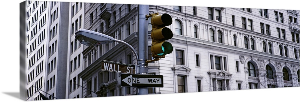 Low angle view of a traffic light in front of a building, Wall Street, New York City, New York State