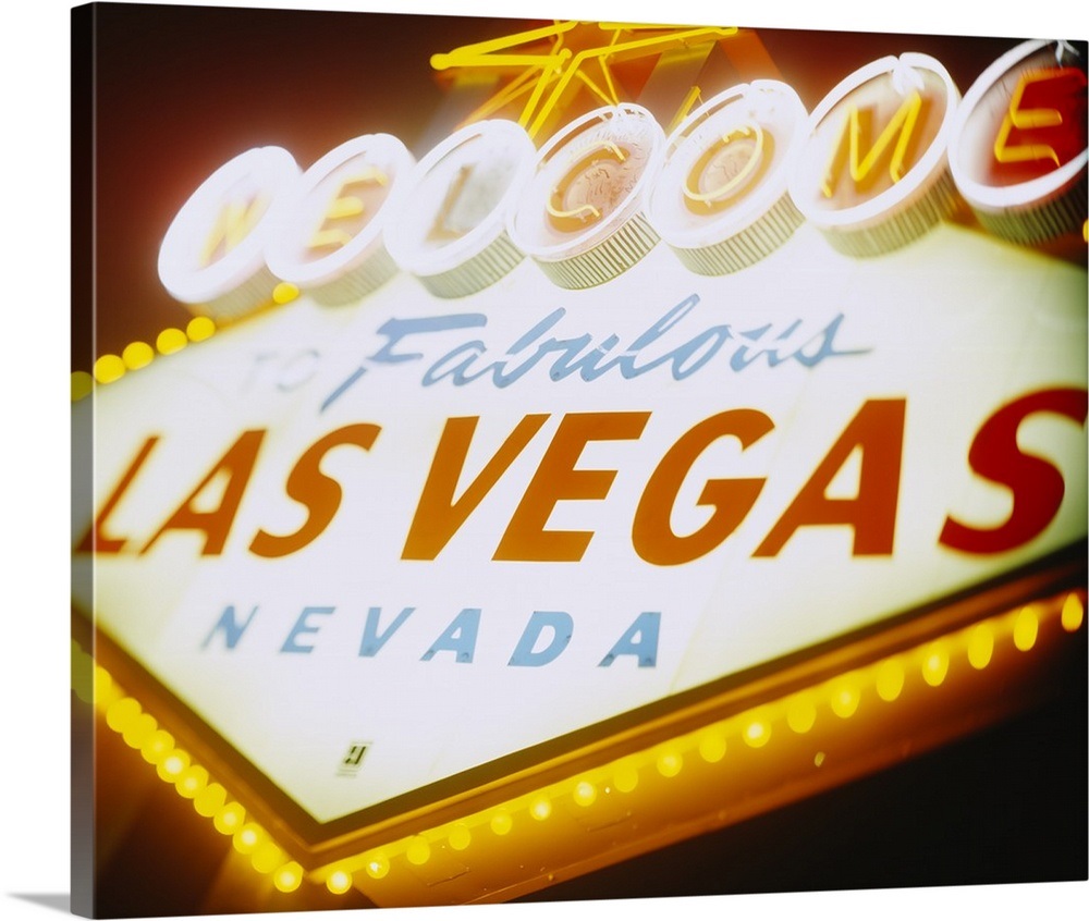 Low angle view of a welcome sign lit up at night, Las ...