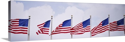 Low angle view of American flags fluttering in wind