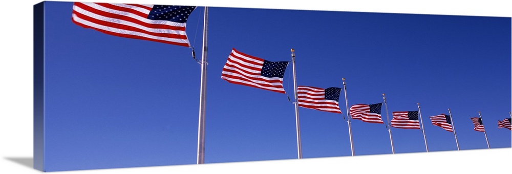 Low angle view of American flags, Washington Monument, Washington DC, USA