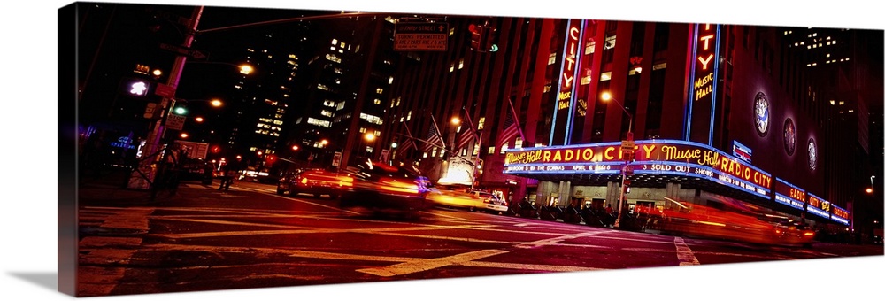 Low angle view of buildings lit up at night, Radio City Music Hall, Rockefeller Center, Manhattan, New York City, New York...
