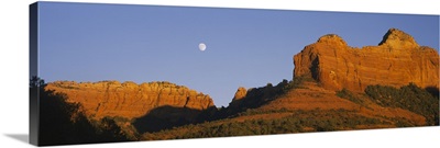 Low angle view of Moon over red rocks, Sedona, Arizona