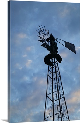 Low angle view of silhouetted windmill, cloudy sky, Iowa