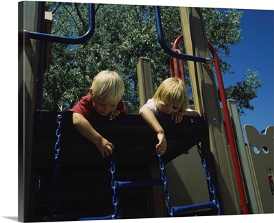Low angle view of two boys playing on the jungle gym, Taos County, New Mexico