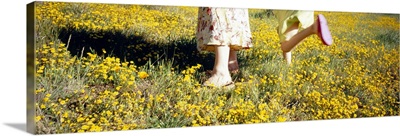 Low section view of a woman and her daughter in a field, Marin County, California