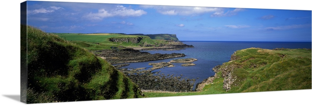 Lush green coastal cliffs, blue sea, Northern Ireland