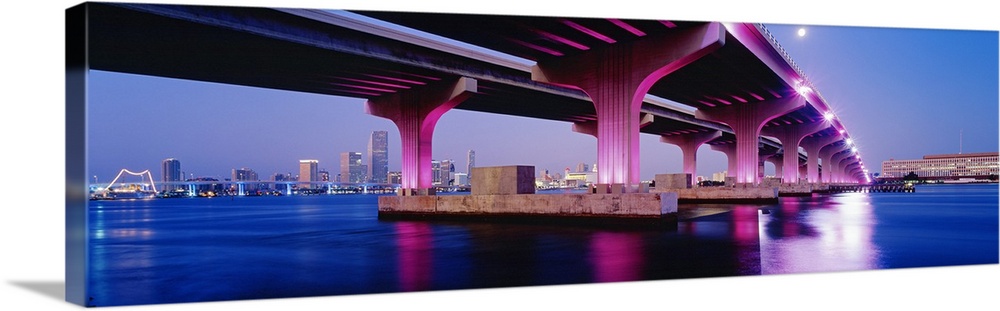 Panoramic photograph on a big canvas of the MacArthur Causeway, lit up at night and reflecting in the waters of the Biscay...