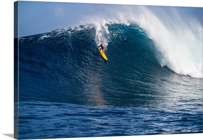 Male surfer surfing wave in Pacific Ocean, Peahi, Hawaii