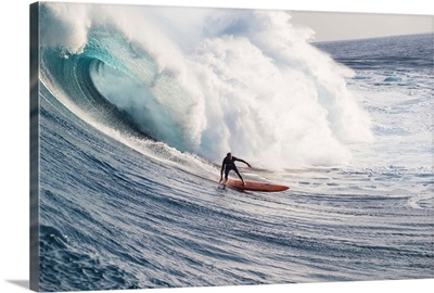 Male surfer surfing wave in Pacific Ocean, Peahi, Hawaii