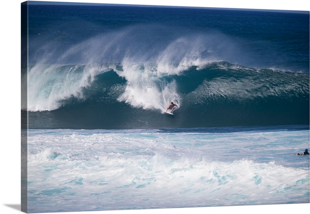 Man surfing down a wave on beach, Hawaii, USA