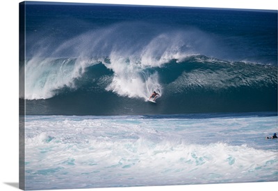 Man surfing down a wave on beach, Hawaii