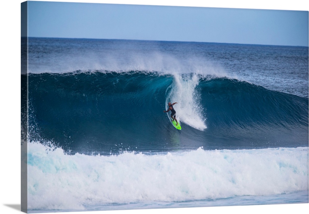 Man surfing down a wave on beach, Hawaii, USA