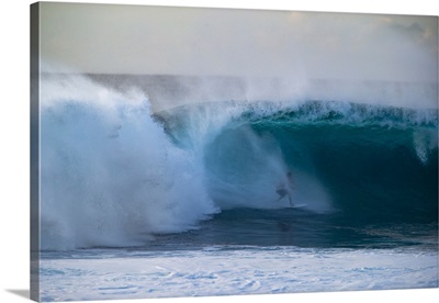 Man surfing down a wave on beach, Hawaii