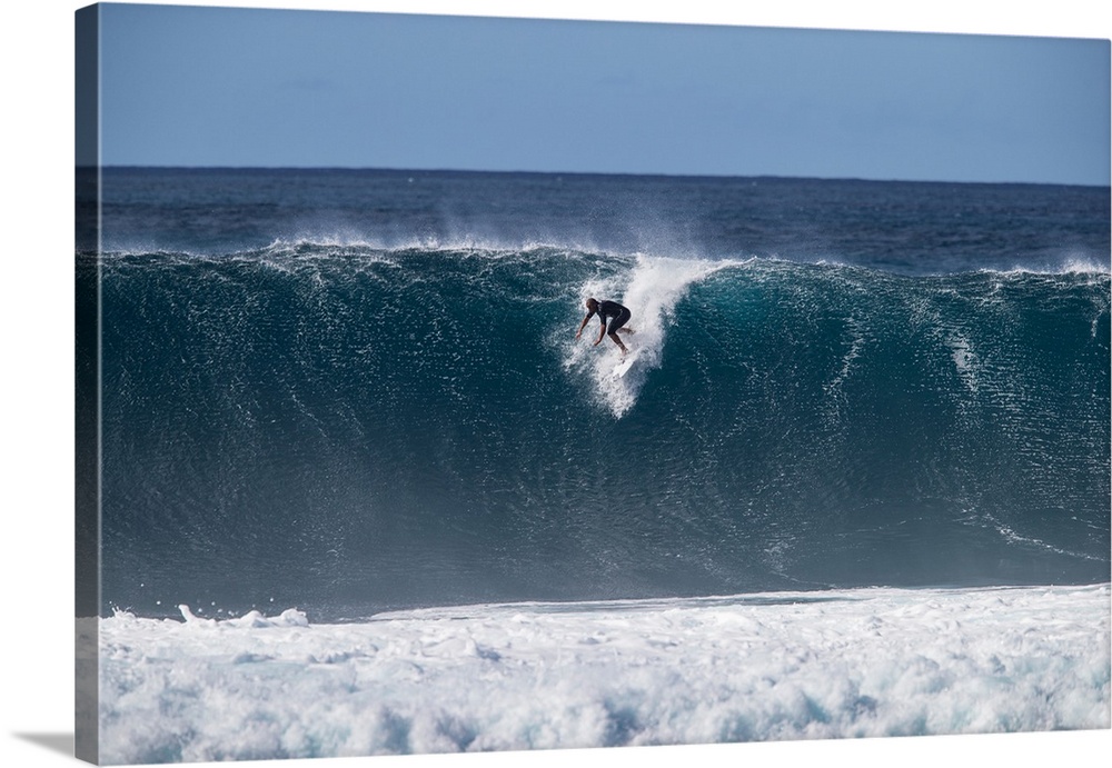 Man surfing down a wave on beach, Hawaii, USA