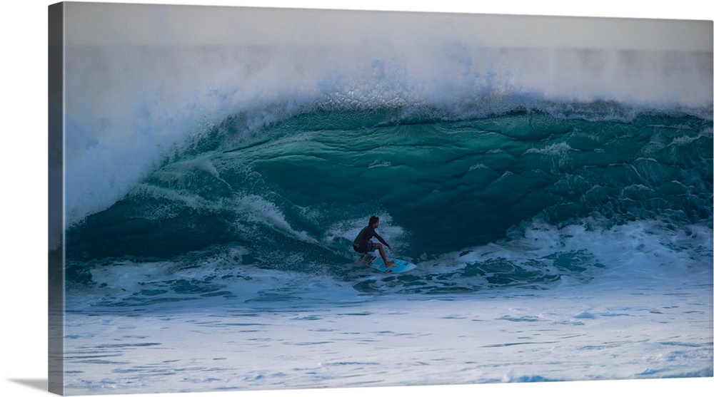 Man surfing down a wave on beach, Hawaii, USA