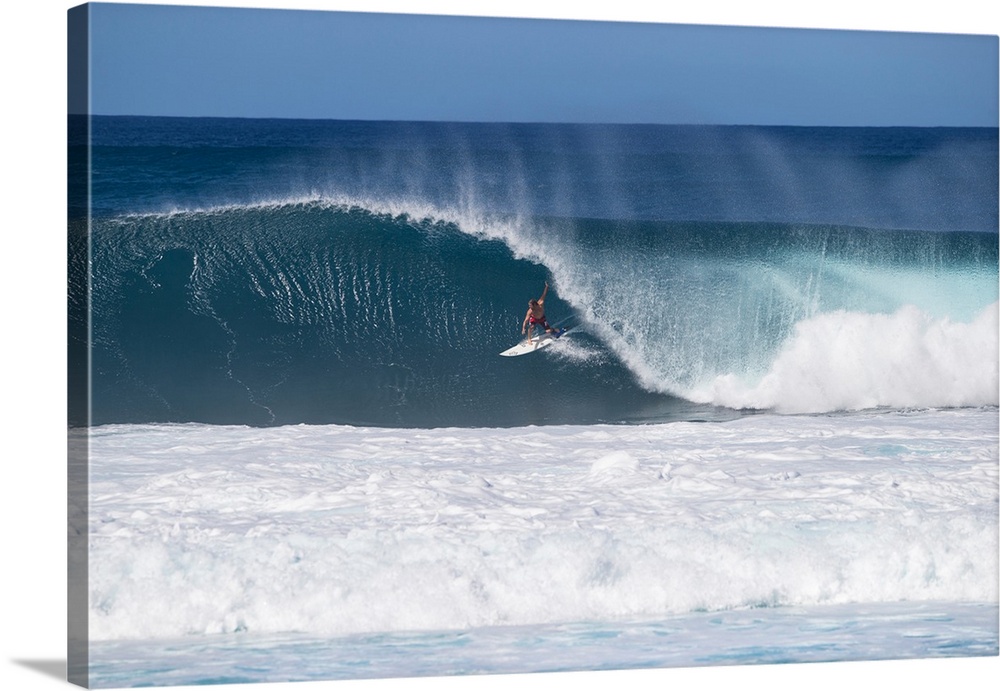 Man surfing down a wave on beach, Hawaii, USA