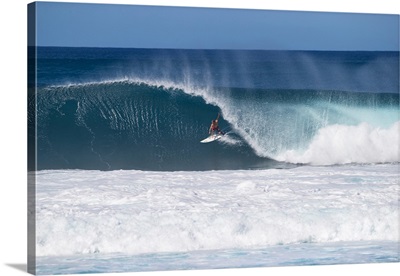 Man surfing down a wave on beach, Hawaii