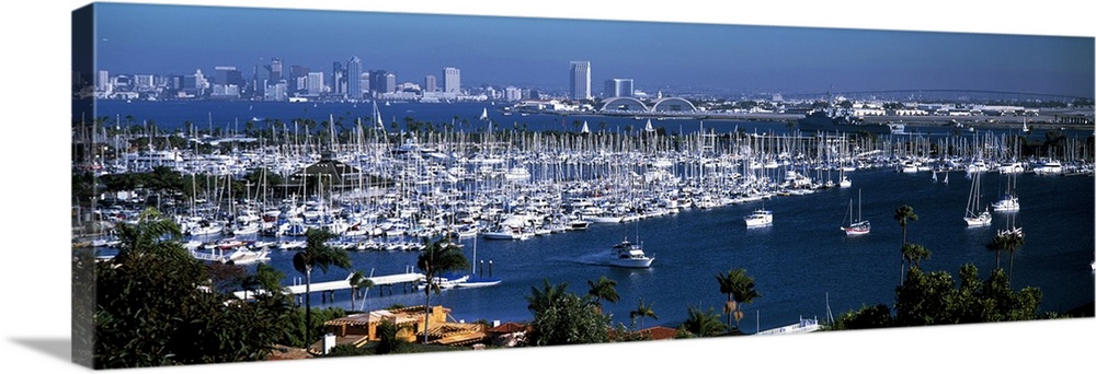 Panoramic photograph on a large wall hanging of a marina packed with boats, in front of the San Diego skyline on the dista...