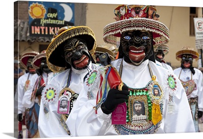 Masked performers celebrating Pentacost at town square, Ollantaytambo