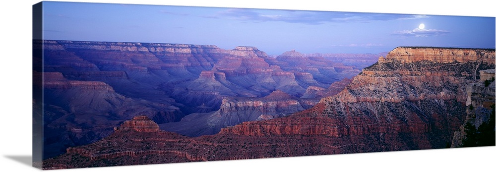 Big panoramic photo from Mather Point in the Grand Canyon in Arizona (AZ) at dusk on a night with a full moon. Warm tones ...