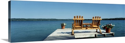 Minnesota, rear view of two Adirondack chairs on a dock