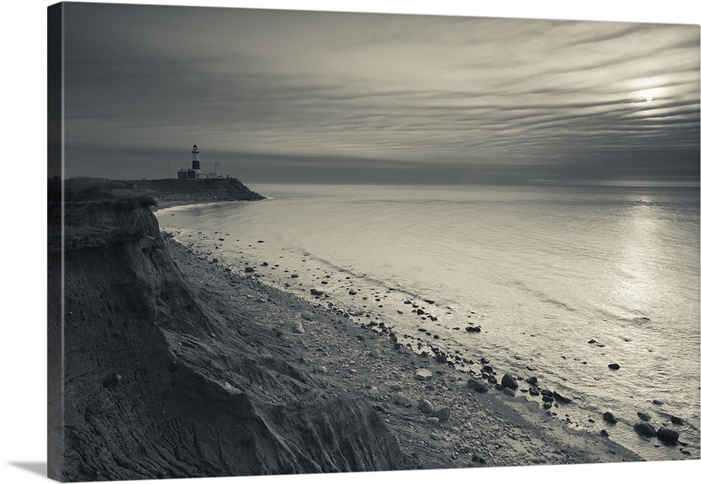 This is a landscape photograph of the shoreline on a partially cloud day.